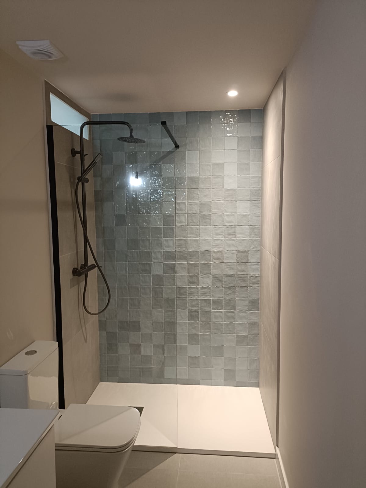 Baño con plato de ducha y mosaico azul